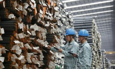 Two workers check steel products at a plant of Hoa Phat Group. Photo courtesy of the company.