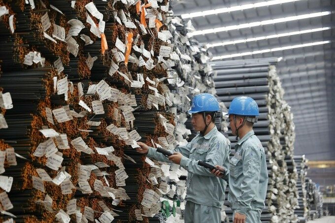 Two workers check steel products at a plant of Hoa Phat Group. Photo courtesy of the company.