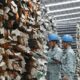 Two workers check steel products at a plant of Hoa Phat Group. Photo courtesy of the company.